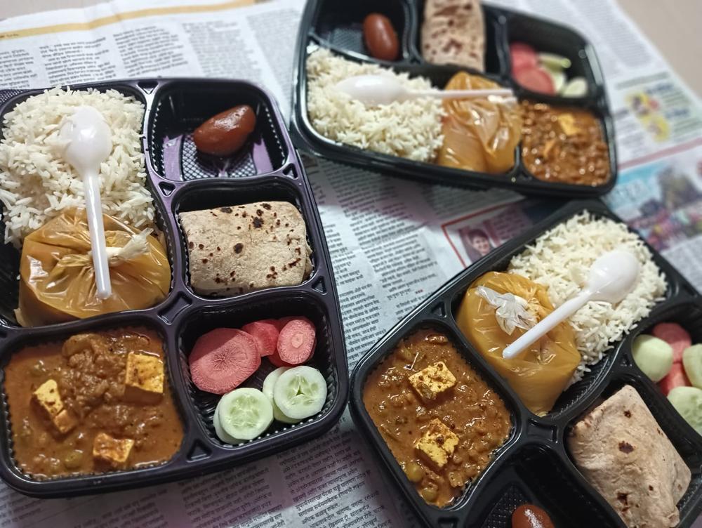 Rows of packed tiffin trays ready for delivery